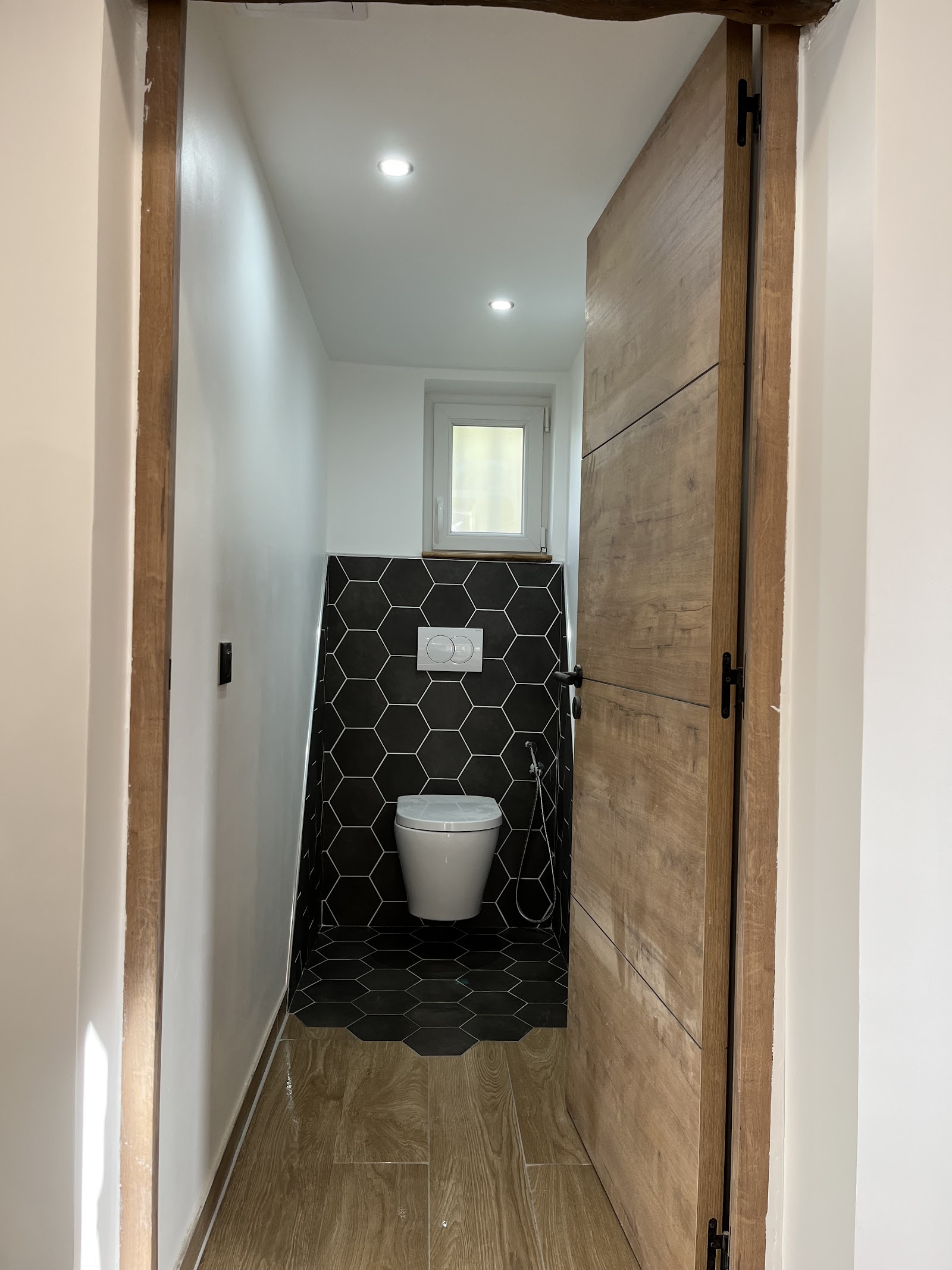 WC suspendu et douchette, finitions carrelage hexagonal